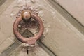 Antique brass door knocker in the shape, door element with metal knob. A very old door handle and lock on a vintage Royalty Free Stock Photo