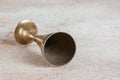 Antique brass goblet on concrete background