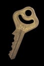 Antique brass keys number 1 on a black background