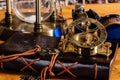 An Antique Brass Nautical Compass and Sundial, with a leather journal, goggles and a brass hourglass