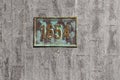 Antique brass plaque with the year 1654 on a granite wall in the Shevchenko City Garden in Kharkiv Ukraine. Metal plate on stone Royalty Free Stock Photo