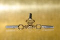 Antique Brass Pocket Watch Keys Laying on Golden Surface Royalty Free Stock Photo