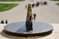 Antique brass sundial in front of a park
