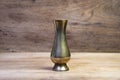 Antique brass vases isolated on a wooden table. Royalty Free Stock Photo