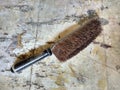 Antique Bristle Dustpan Brush on Worn Linoleum Countertop