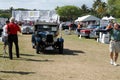 Antique british car driving on field