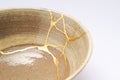 Antique broken bowl repaired with gold kintsugi technique