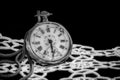 Antique broken pocket watch on black velvet fabric and white lace. Royalty Free Stock Photo