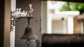 Antique Bronze bell hangin on the farmhouse door