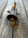 Antique bronze bell on an old wooden door Royalty Free Stock Photo