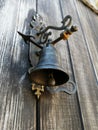 Antique bronze bell on an old wooden door Royalty Free Stock Photo