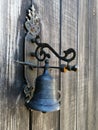 Antique bronze bell on an old wooden door Royalty Free Stock Photo