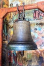 Russia, Uglich, July 2020. Antique bell against the background of the murals of the Orthodox Church.