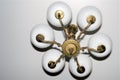 Antique bronze chandelier close-up on a white ceiling background.