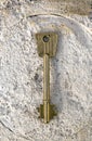 Antique bronze key on rough surface Royalty Free Stock Photo