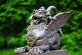 Antique bronze statue of chinese winged dragon on bridge at park