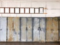 Antique brown wooden photo frame on dirty wall over old steel cabinets. Royalty Free Stock Photo