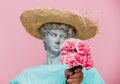 Antique bust of male in hat with carnations bouquet