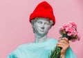 Antique bust of male in hat with carnations bouquet