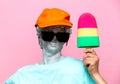 Antique bust of male in hat with sunglasses and toy ice-cream