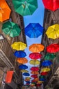 Antique bystreet decorated with colored umbrellas. Royalty Free Stock Photo