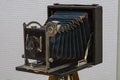 Antique camera with exposed internal components, predominantly black and metallic, placed against a light background in even Royalty Free Stock Photo