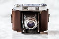 Antique Camera with Leather Holster on Marble Background