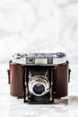 Antique Camera with Leather Holster on Marble Background