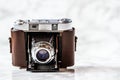 Antique Camera with Leather Holster on Marble Background