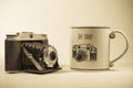 Antique Camera Next To Funny Coffee Cup