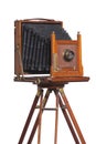 Antique camera on old tripod isolated on white Royalty Free Stock Photo