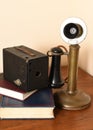 An antique camera and telephone with books Royalty Free Stock Photo