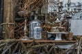 Antique candlestick and Dry plant, Dried flowers, Pine cones with Glass bottle Decorate on wooden table in cafe Royalty Free Stock Photo