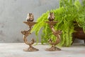 Antique candlesticks on concrete background