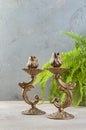 Antique candlesticks on concrete background