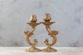 Antique candlesticks on concrete background