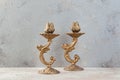 Antique candlesticks on concrete background