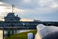 Antique cannon aimed at a modern aircraft carrier Royalty Free Stock Photo