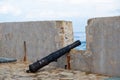 Antique cannon put on opening of Firkas Fortress worn wall at Old Town of Chania Crete, Greece