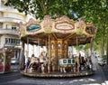 Antique carousel running in a French square