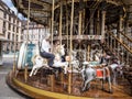 A woman rides the old carousel in the center of Strasbourg, France