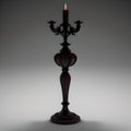 Antique carved wooden table with a single lit candle resting on its surface