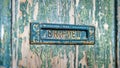 Antique cast iron mailbox with authentic details in a weathered wooden door