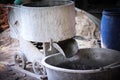 Antique cement mixer wheelbarrow used in construction site Royalty Free Stock Photo