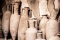 Antique ceramic jugs, pots and vases in ancient city Ercolano of roman times ruined by volcano Vesuvius in Italy Royalty Free Stock Photo