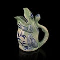 Antique ceramic jug in the shape of a frog.