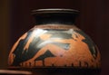 Antique ceramic red-figure psykter depicting a reclining woman with a bowl in her hand during a symposium, close-up