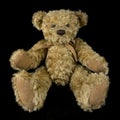 Vintage teddy bear toy on isolated black background