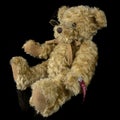 Vintage teddy bear toy on isolated black background