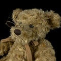 Vintage teddy bear toy on isolated black background